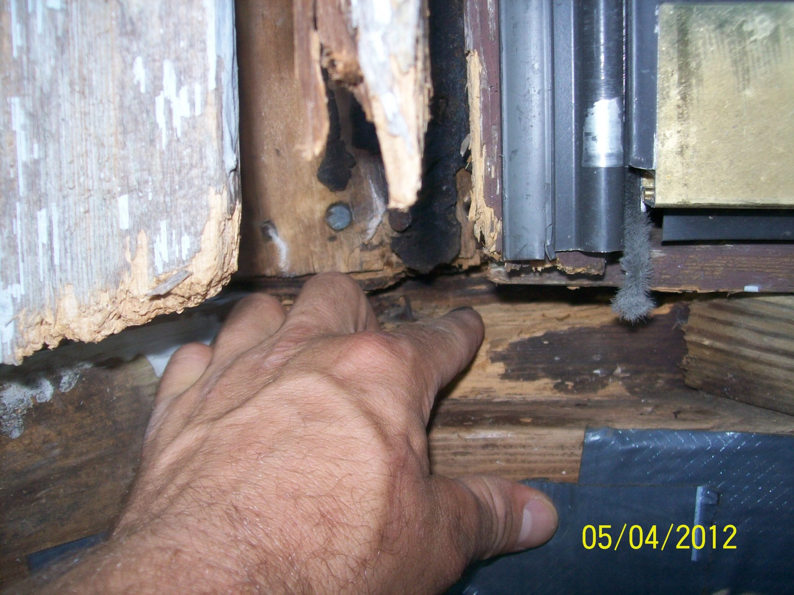 Picture of rotted door sill, jamb, framing and subfloor