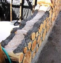 Cordwood wall with insulation between inside and outside mortar