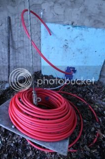 Picture of BK's hanging spool technique for laying tubing into compost water heater